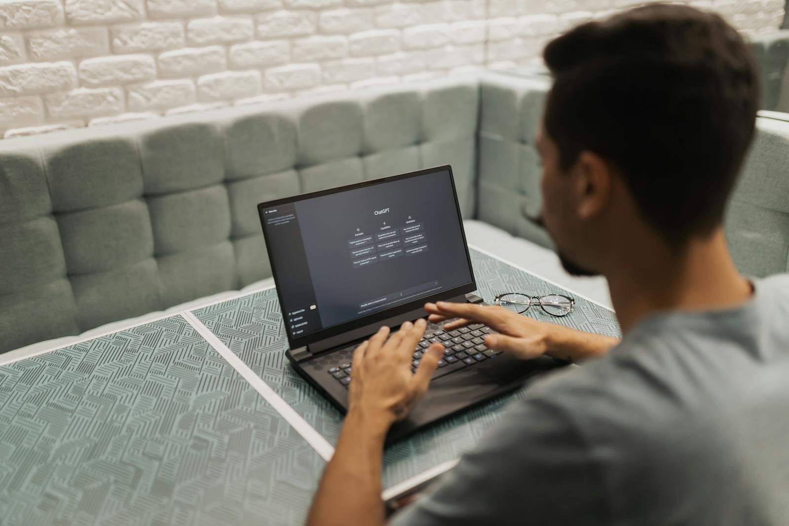 A man working on a laptop in a cozy, modern office space with a focus on technology.